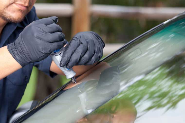 A Northern Lites Autoglass technician repairing a windshield