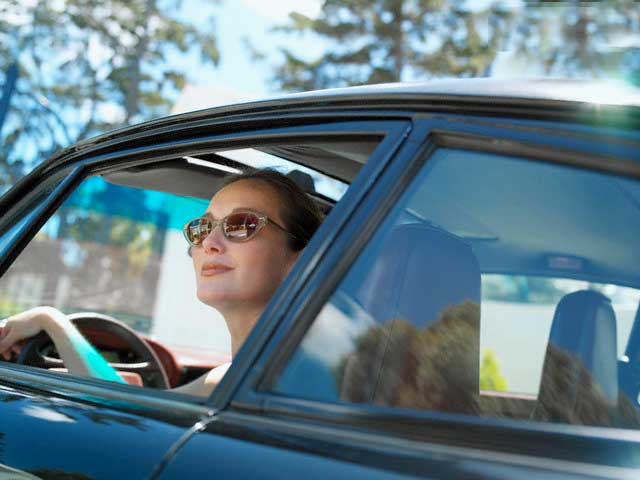 Woman in car with new auto glass installed by Northern Lites Autoglass