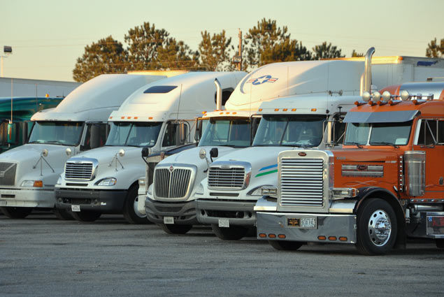 A row of semi trucks with new windshields installed in Thompson, Manitoba
