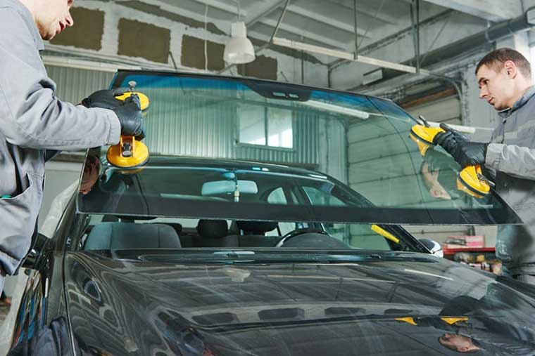 Windshield technicians installing a new windshield in Thompson, MB