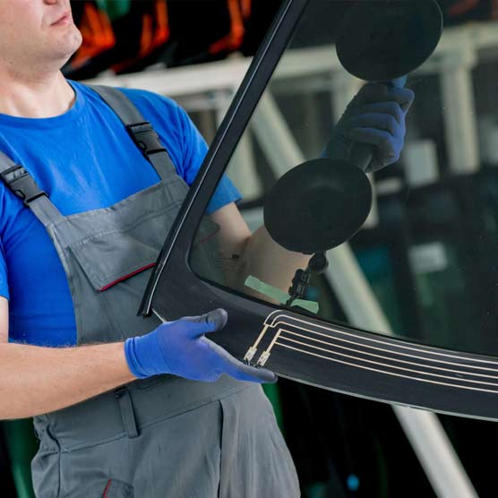 A Northern Lites Auto Glass technician replacing a windshield in Thompson, Manitoba